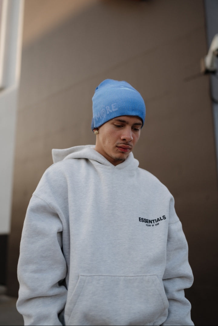 Neptune Beanie in blue worn by a man in a gray hoodie, ideal for winter style and comfort.